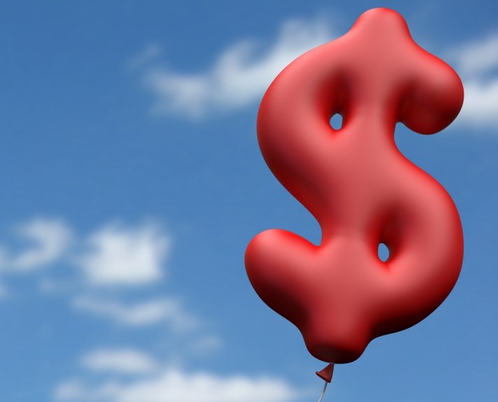 A red ballon shaped as a dollar symbol. inflation concept.